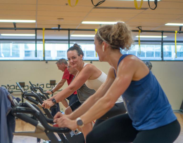 Smiling In Group Exercise Cycling Class