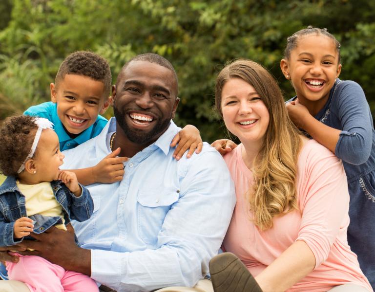 Family Smiling In Park