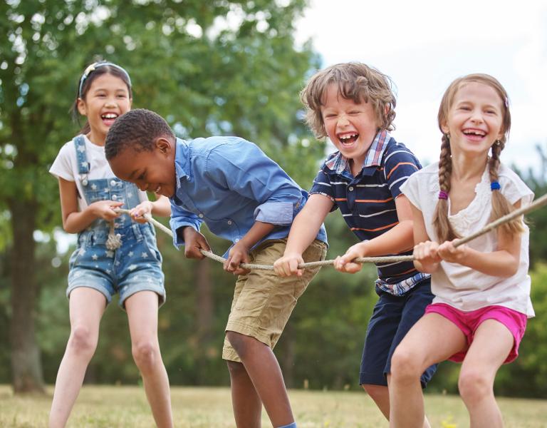 Kids Playing Tug Of War At YMCA Summer Day Camp