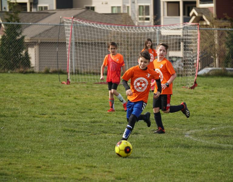 Dribbling Down The Field At YMCA Youth Soccer