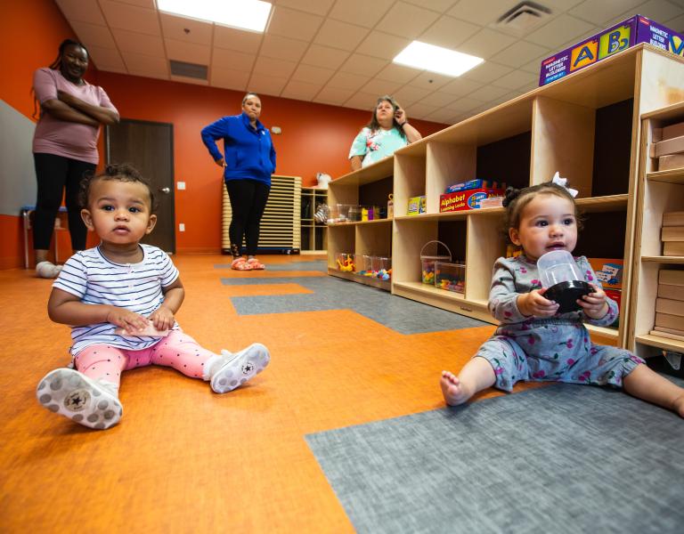 Infants engaging in floor play at a care center