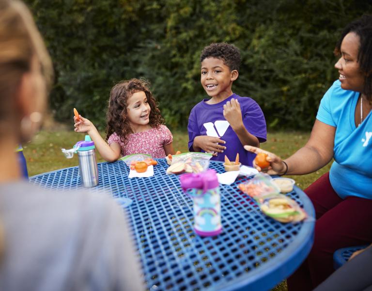 Camp participants enjoy lunch outside