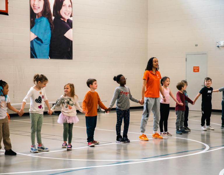 Youth PE participants line up in gymnasium for a game