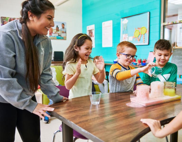 Child care kiddos conduct a science experiment at the YMCA