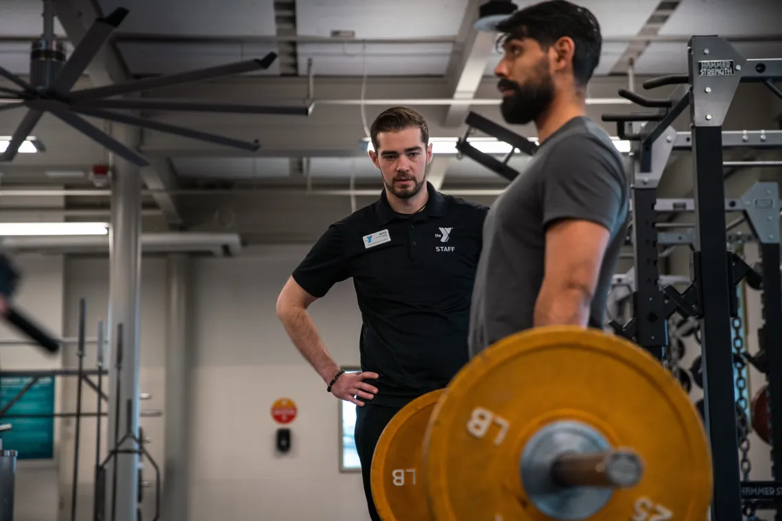 Kickstart instructor observing member implement learned deadlift form