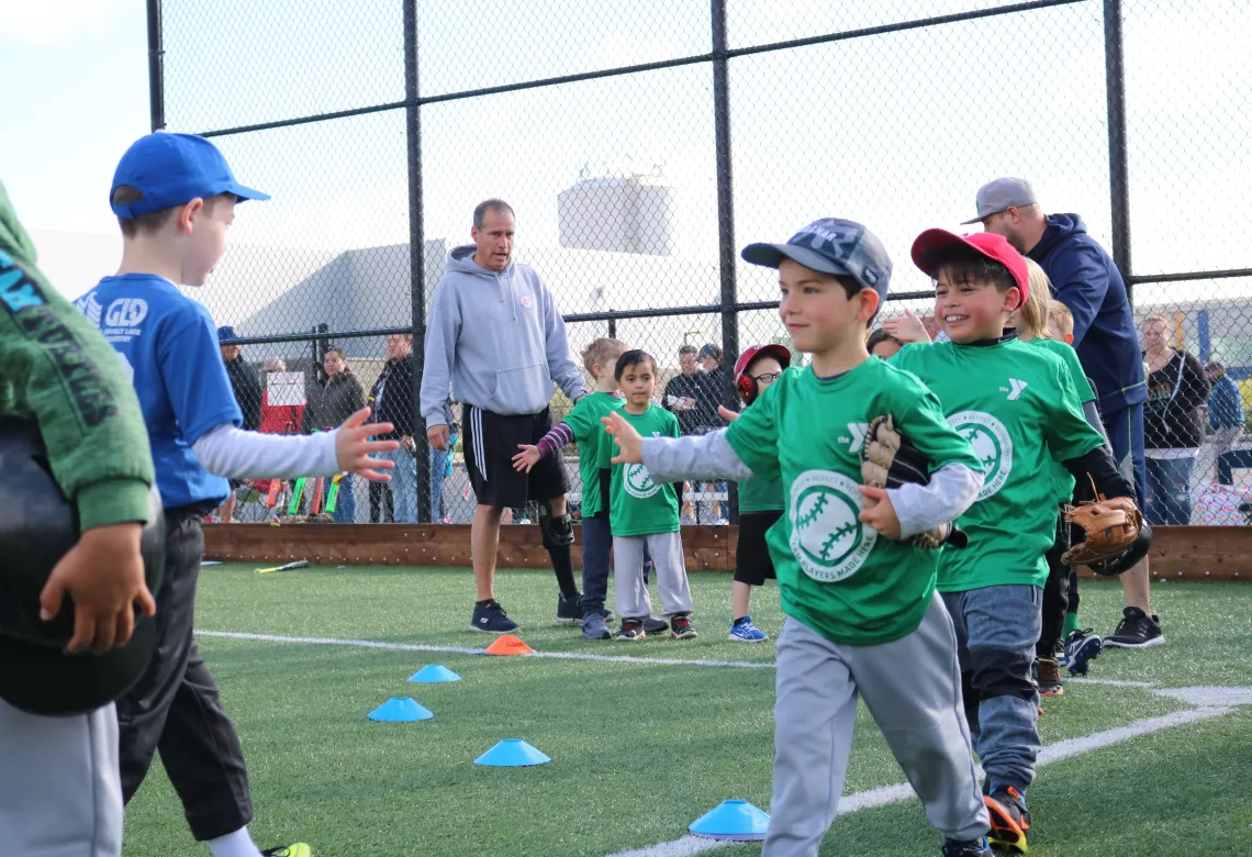 T-ball teams lined up for post game high fives
