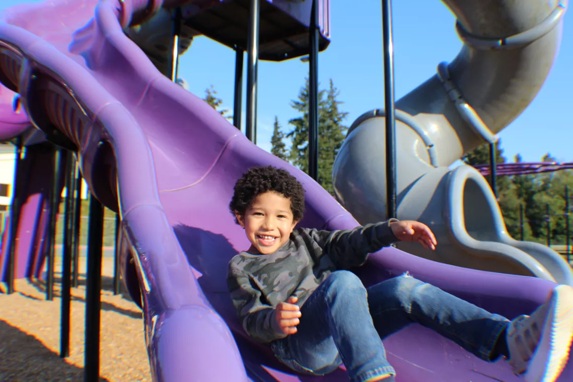 Smiling on Slide at YMCA Early Learning Center