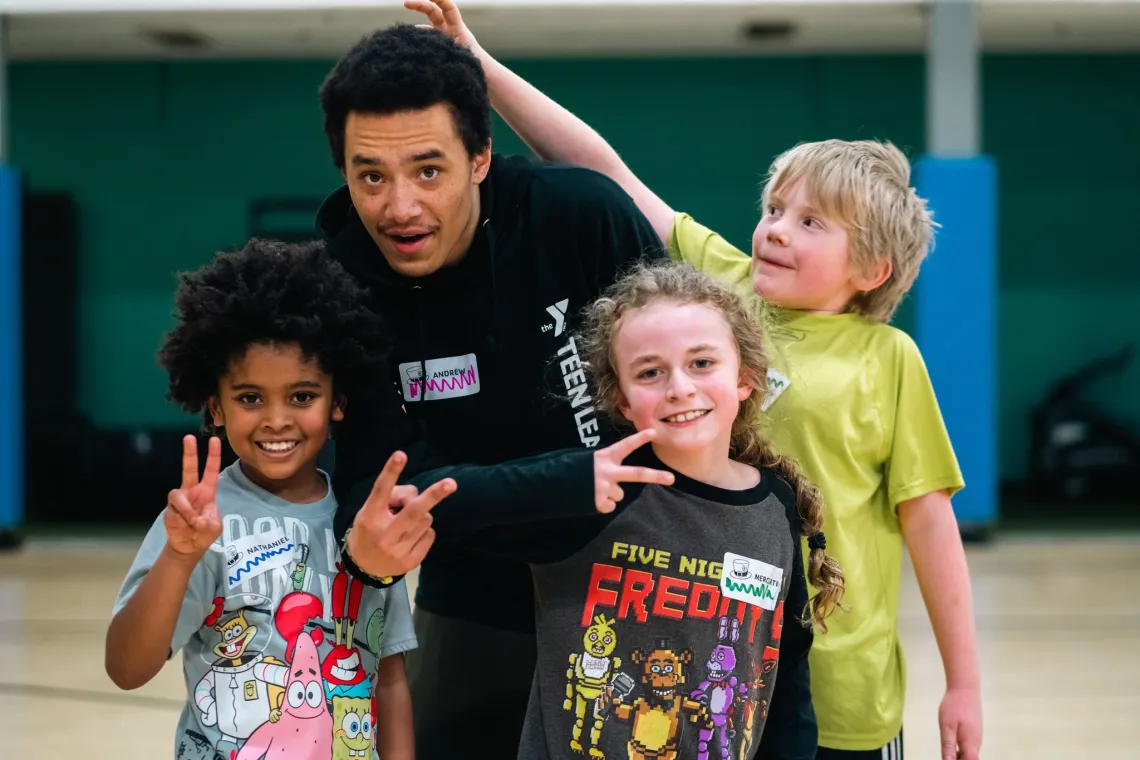 Kids night out group poses with peace signs at the YMCA