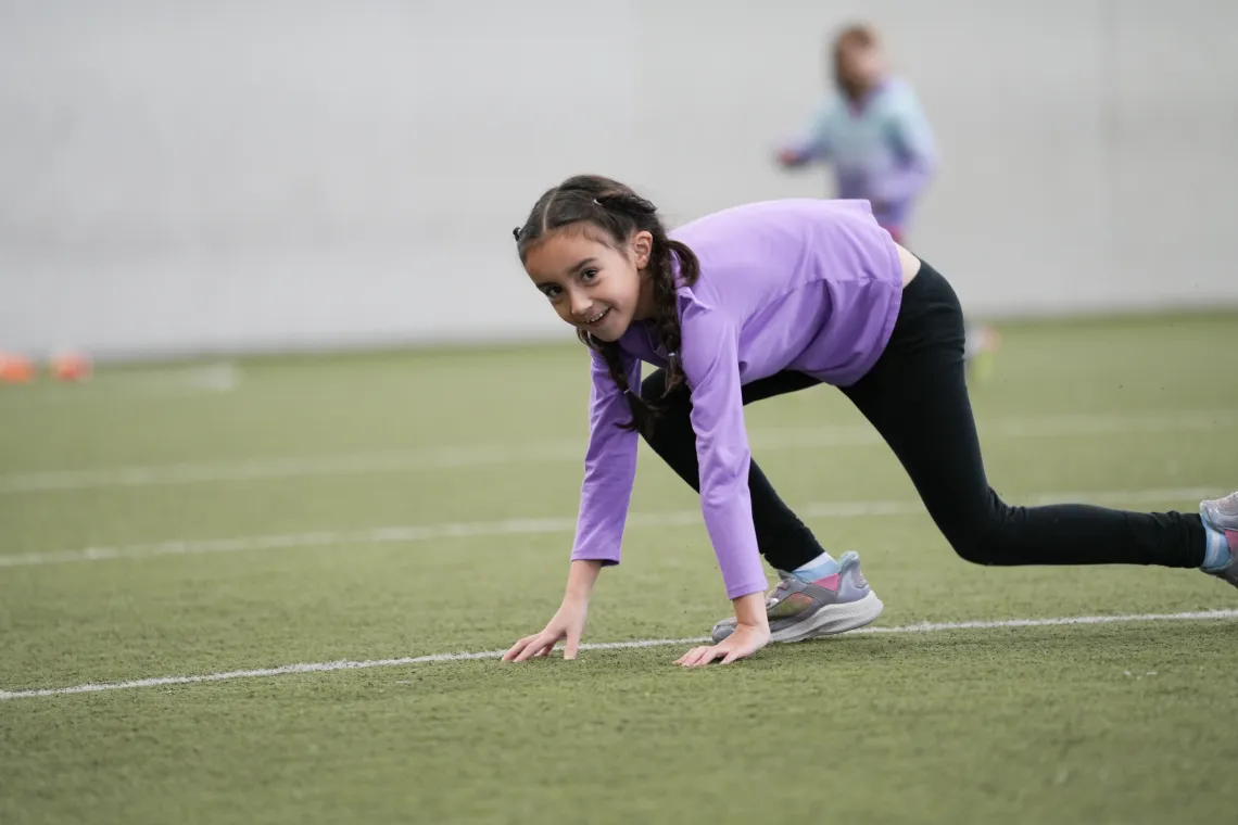 Break camp participant lines up for a sprint in the indoor turf at the YMCA