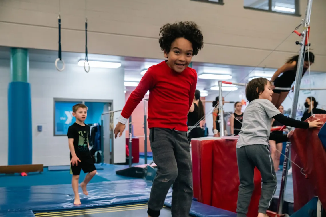 Boy in Red Jumping at YMCA Gymnastics