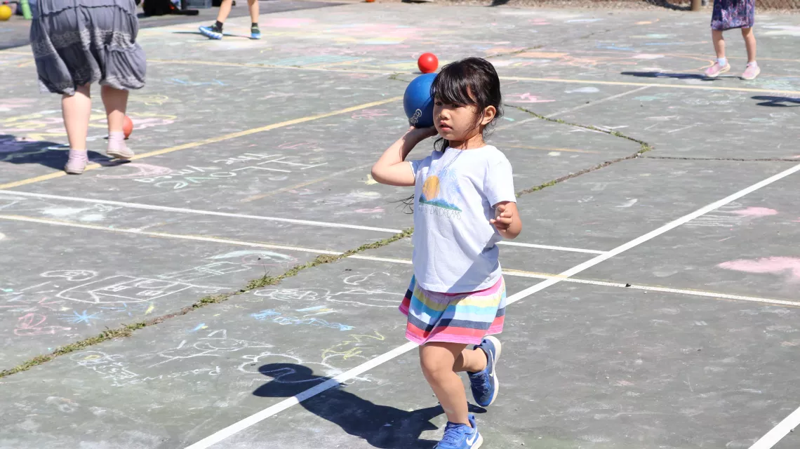 Action shot of a summer camp participant throwing a gatorskin ball at the YMCA