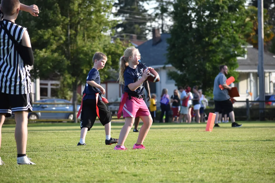 Action shot of a quarterback getting ready to throw the football at the YMCA