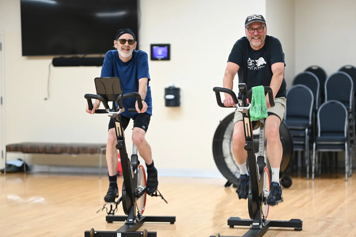 Two Friends Cycling in YMCA Spin Class