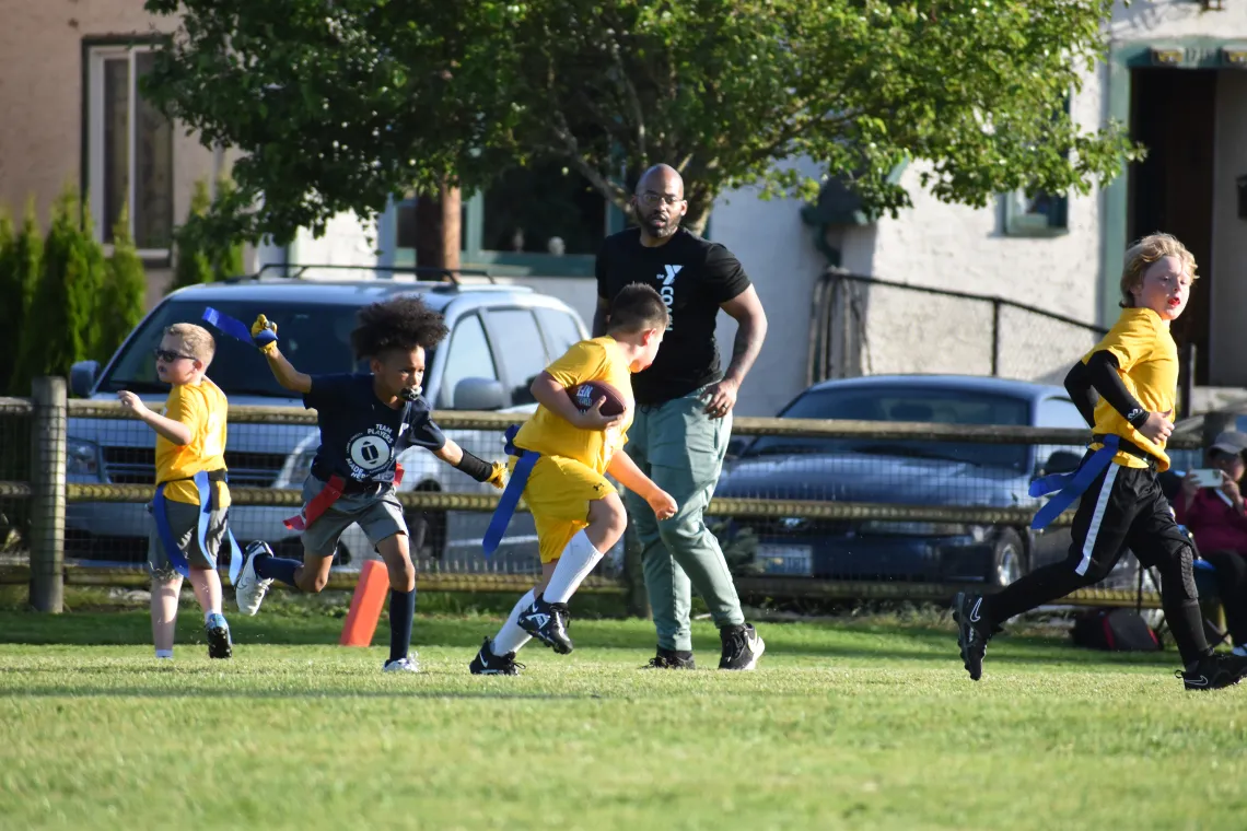 Defender Grabbing Flag at YMCA Youth Flag Football League