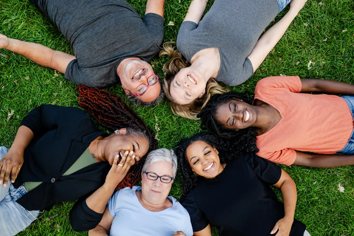 Happy people laying on the grass