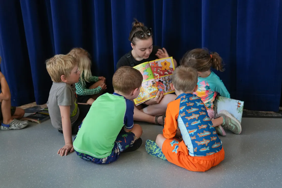YMCA Child Care Staff Reading a Book in a Circle