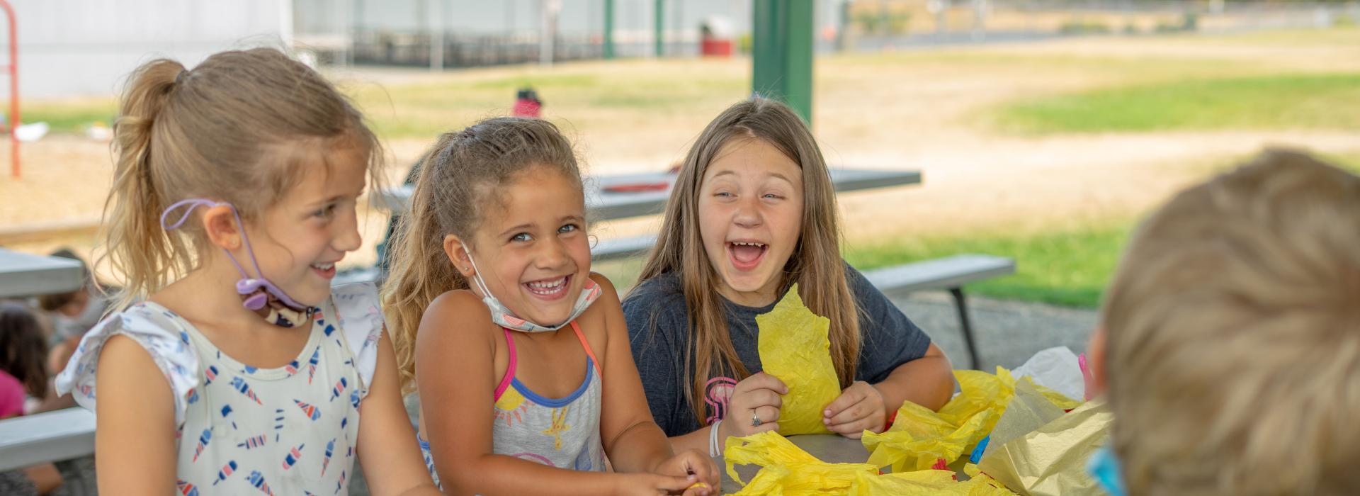 YMCA Summer Day Camp Kids Laughing At Table