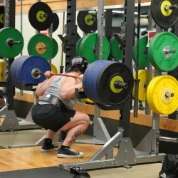 Action shot of someone using the new squat rack at the YMCA