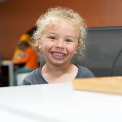 YMCA Child Care Big Smile at Table