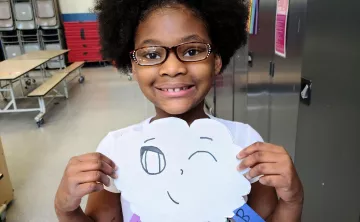 Girl Showing Off Art in YMCA Visual Arts Class