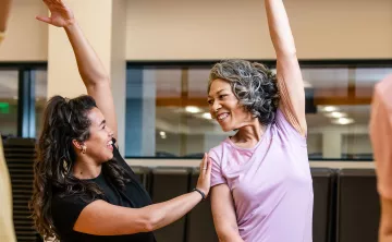 Active Older Adult Stretching In YMCA Group Exercise Class