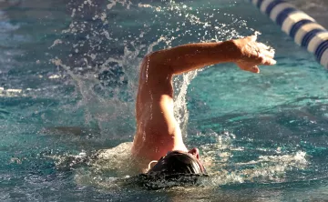 Man Swimming Laps At YMCA Pool