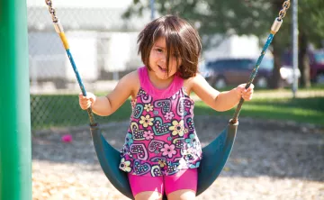 Smiling and Swinging At YMCA Child Care