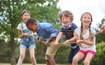 Kids Playing Tug Of War At YMCA Summer Day Camp