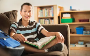 Teen reading on couch