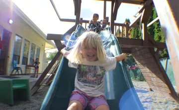 Children in the full-time preschool playing on the playground at the UP ELC