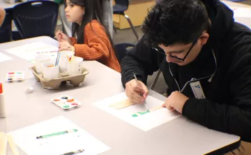 Site Leader Sean Chavez 18, working on an art project with the After School Care participants