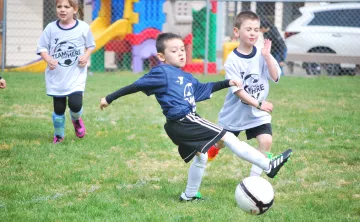 Youth soccer player making a kick