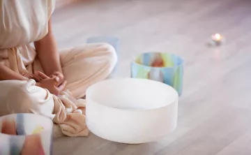 Image of a person meditating with a sound bowl