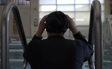 Shot of a swimmer adjusting their swim cap before starting some laps at the YMCA