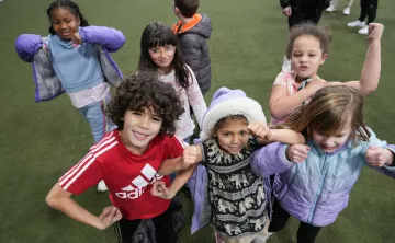Campers pose for a picture on the covered turf at the YMCA