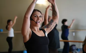 Action shot of a barre instructor mid lesson at the YMCA