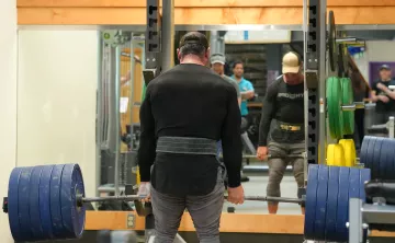 Action shot of someone deadlifting at the YMCA