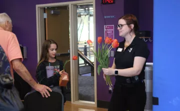 YMCA staff hands out daffodils in spring at the YMCA
