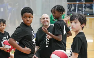 Shot of a team huddle with the coach during a basketball tournament at the YMCA