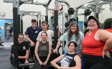Brad and his weightlifting group pose in the gym. 