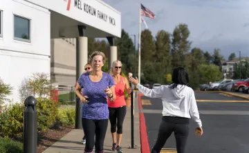 Action shot of bootcamp participants running outside at the YMCA