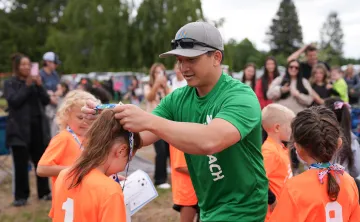 Youth Soccer Coach Giving Player a Medal