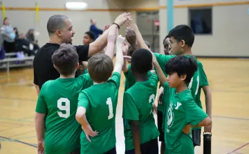 Youth Sports League team on the basketball court highfiving