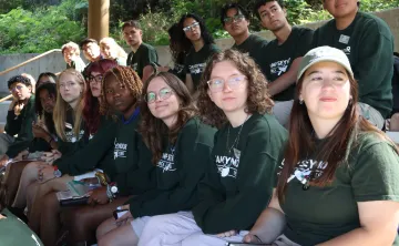Camp Seymour teen leadership participants sit together during a leadership training session, learning teamwork, responsibility, and counselor development at YMCA Camp Seymour.