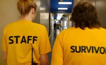 Livestrong Staff and Survivor wearing yellow shirts and walking the indoor track