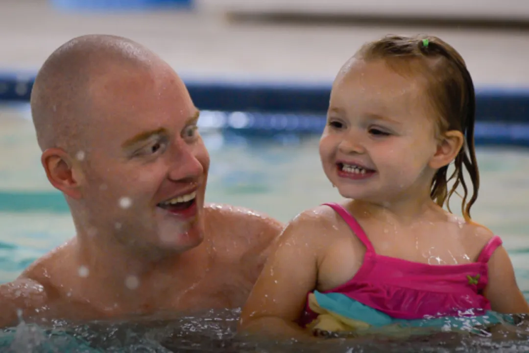 Father and daughter swimming