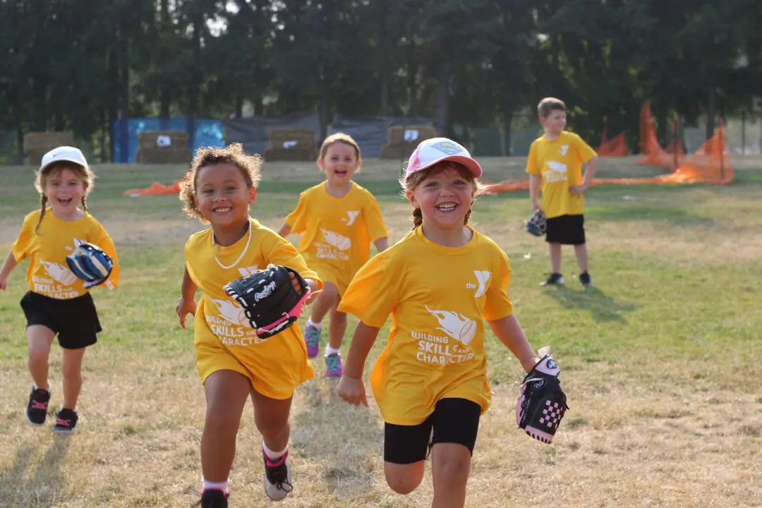 Tball skills youth running with mits in hand