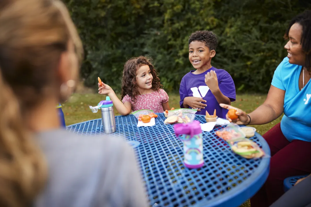 Camp participants enjoy lunch outside