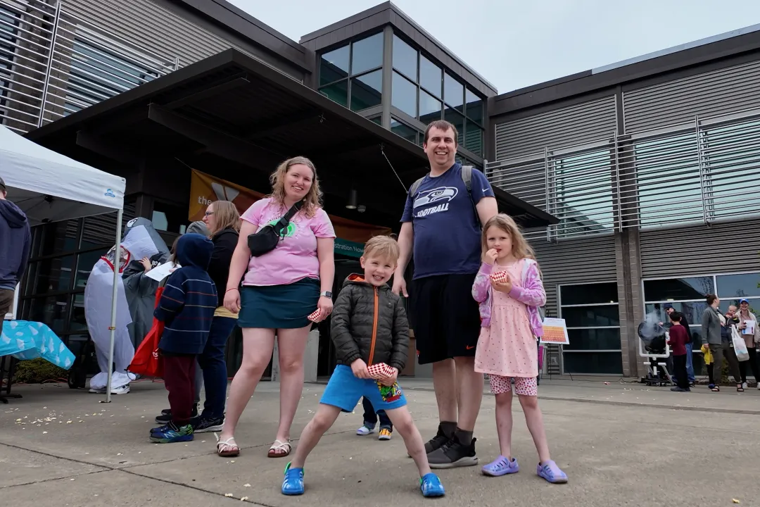 Family Poses outside during Healthy Kids Day at the YMCA