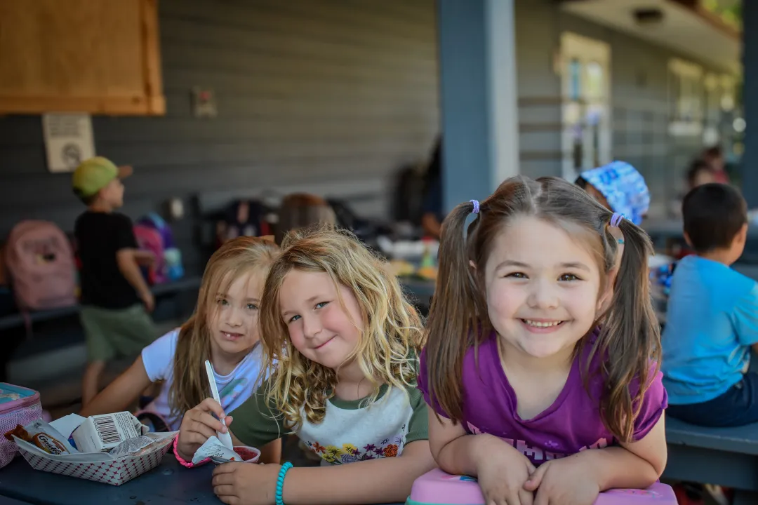 Three Friends Smiling With Summer Camp Art Project